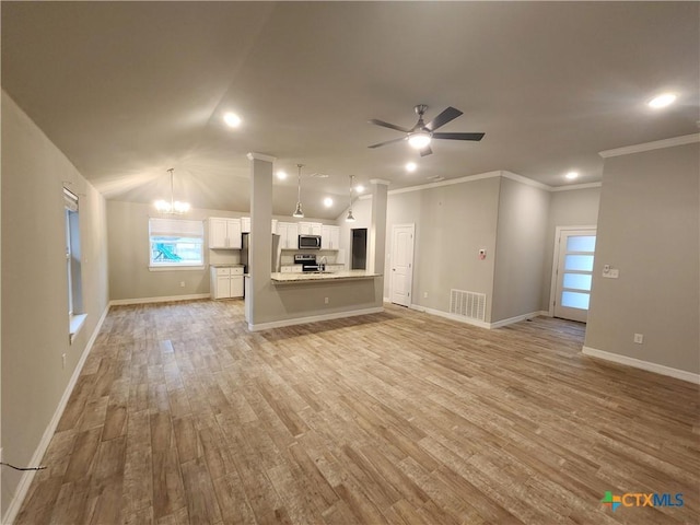 unfurnished living room with crown molding, ceiling fan with notable chandelier, lofted ceiling, and light wood-type flooring