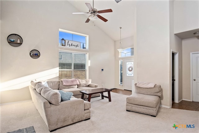 carpeted living room with high vaulted ceiling and ceiling fan