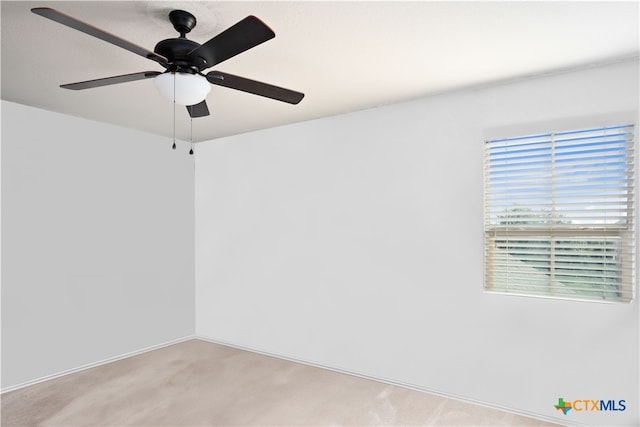 unfurnished room with light colored carpet and ceiling fan