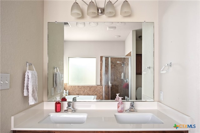 bathroom featuring shower with separate bathtub and sink