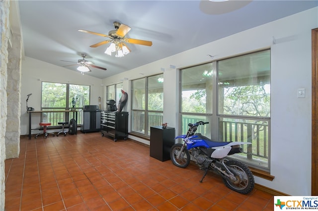 sunroom featuring ceiling fan and vaulted ceiling