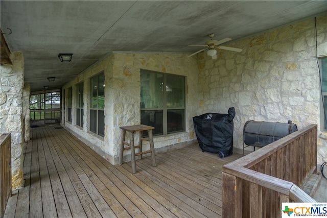 wooden terrace with grilling area and ceiling fan