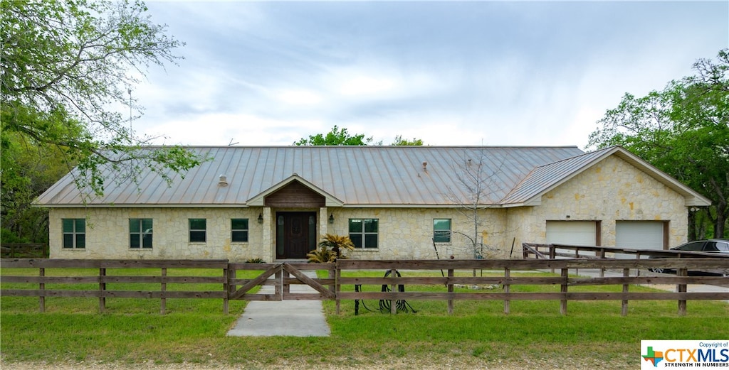 single story home with a front lawn and a garage