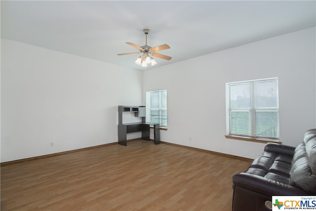 living room featuring wood-type flooring and ceiling fan