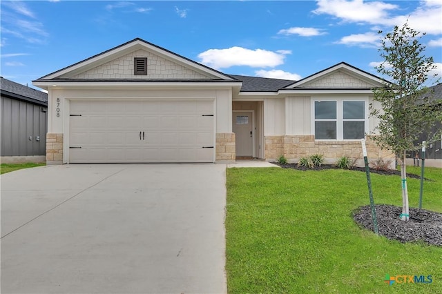 view of front of home with a garage and a front lawn