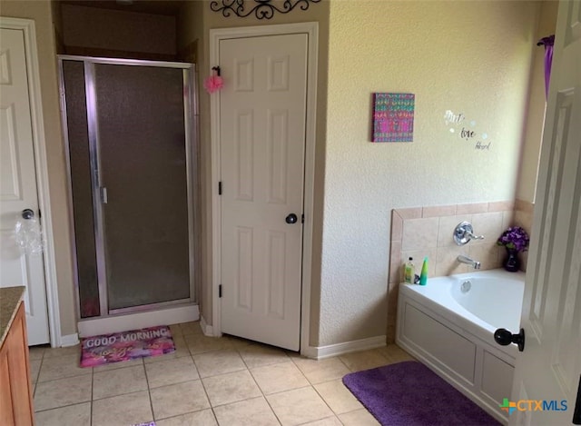 bathroom featuring vanity, tile patterned flooring, and plus walk in shower