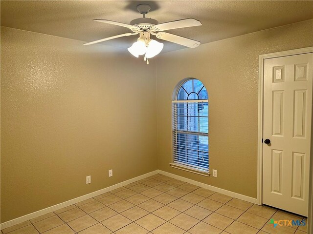 tiled bedroom featuring ceiling fan