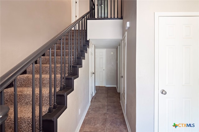 stairs with tile patterned floors