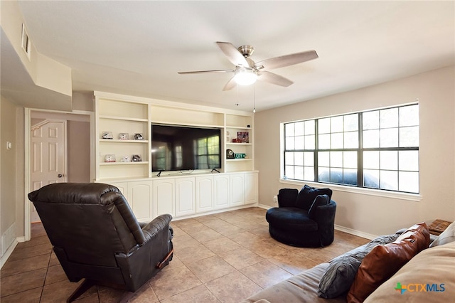 tiled living room featuring built in features and ceiling fan