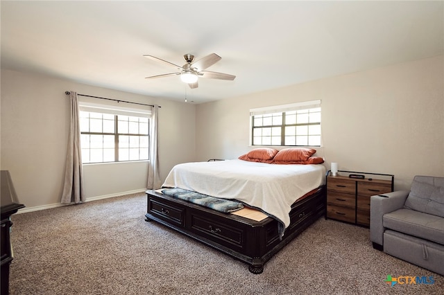 bedroom with multiple windows, ceiling fan, and carpet