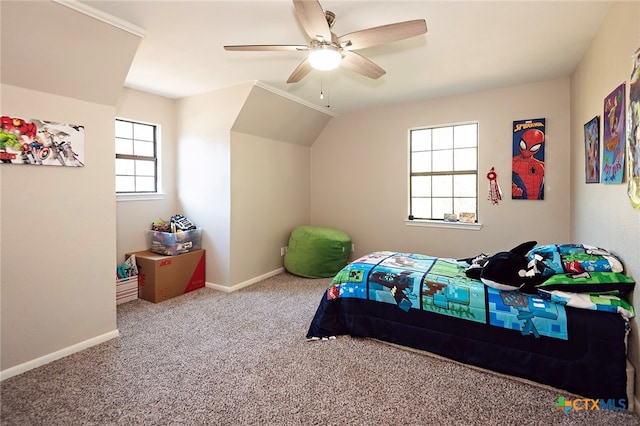 carpeted bedroom with multiple windows, vaulted ceiling, and ceiling fan