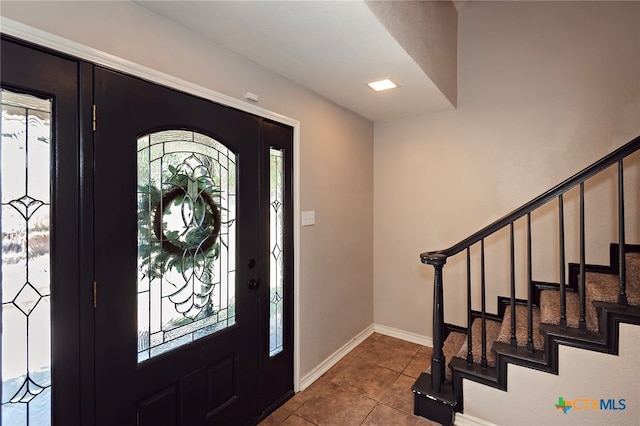 foyer entrance featuring light tile patterned flooring