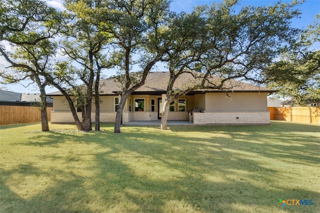4121 Turning Leaf Dr, Nolanville, TX 76559 - rear view of property with stucco siding and a patio