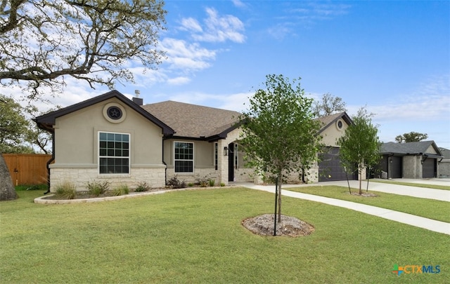 4121 Turning Leaf Dr, Nolanville, TX 76559 - single story home with stone siding, stucco siding, a garage, driveway, and a chimney