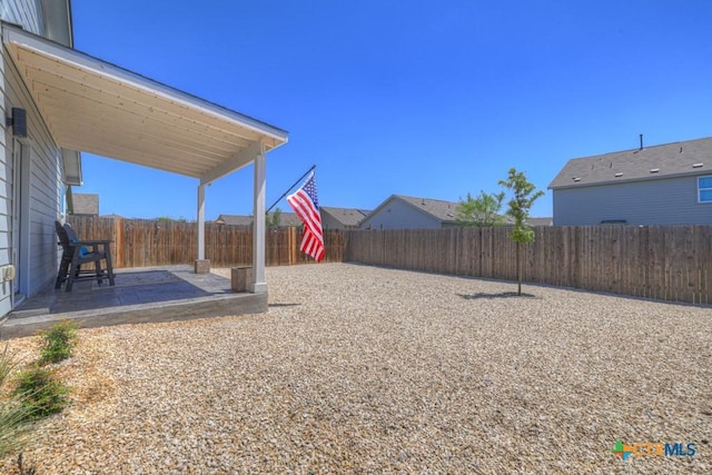 view of yard featuring a patio and a fenced backyard