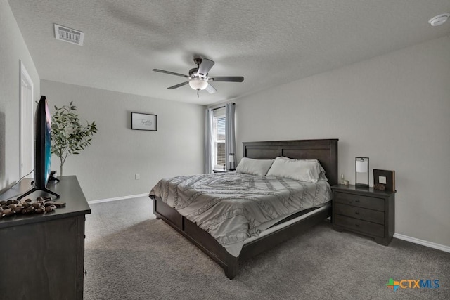 bedroom featuring a textured ceiling, carpet flooring, baseboards, and visible vents