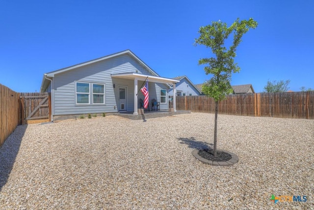 bungalow with a patio area and a fenced backyard