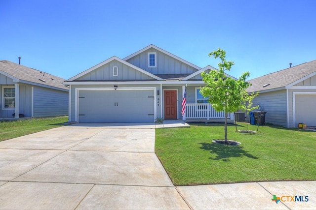view of front of property with board and batten siding, a porch, a front yard, a garage, and driveway