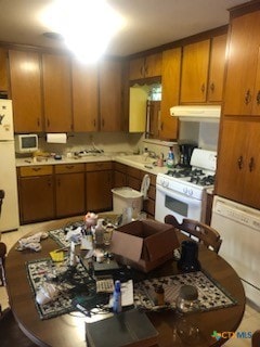 kitchen featuring white appliances and sink