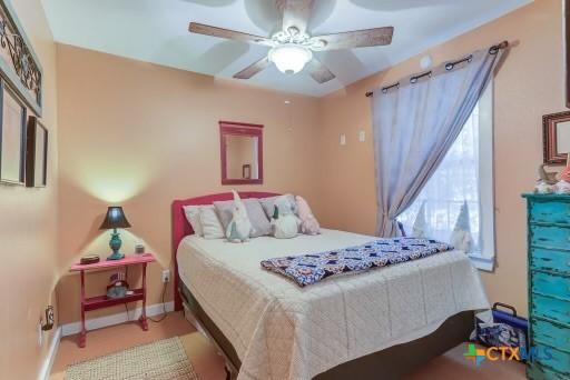 162 Canyon Crk, Canyon Lake, TX 78133 - bedroom featuring baseboards and ceiling fan
