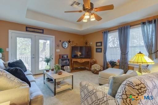 162 Canyon Crk, Canyon Lake, TX 78133 - living room with ceiling fan, a healthy amount of sunlight, french doors, and a raised ceiling