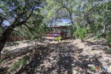 162 Canyon Crk, Canyon Lake, TX 78133 - view of yard featuring a wooden deck