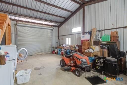 162 Canyon Crk, Canyon Lake, TX 78133 - garage featuring freestanding refrigerator and metal wall