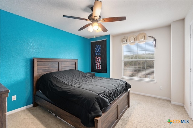 bedroom featuring light colored carpet and ceiling fan