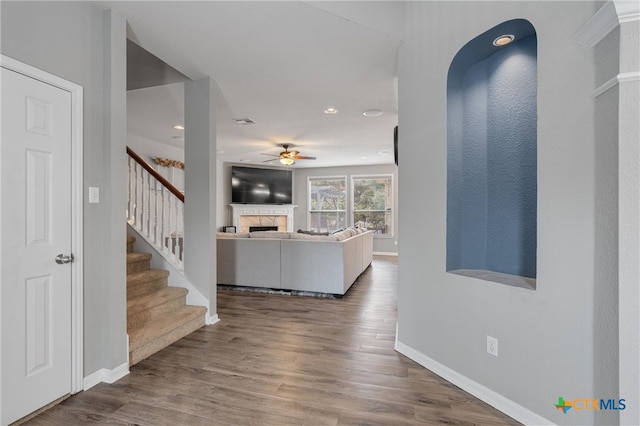 interior space featuring wood-type flooring and ceiling fan