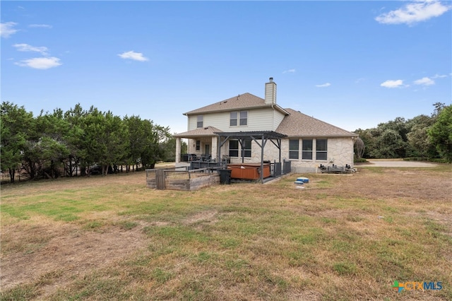 back of property with a lawn and a patio