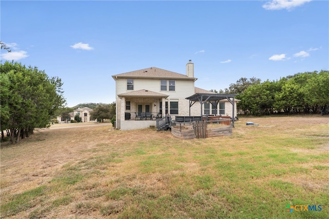 rear view of house with a yard and a pergola