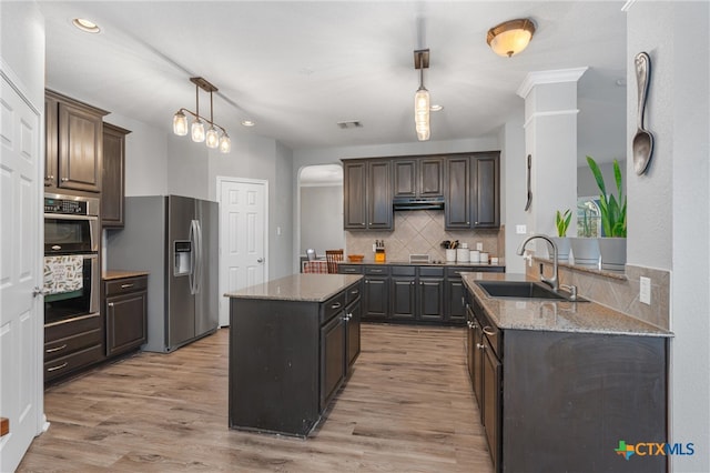 kitchen featuring appliances with stainless steel finishes, sink, dark brown cabinets, and light hardwood / wood-style floors