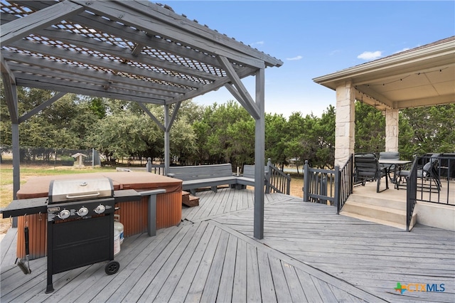 deck with a hot tub, grilling area, and a pergola