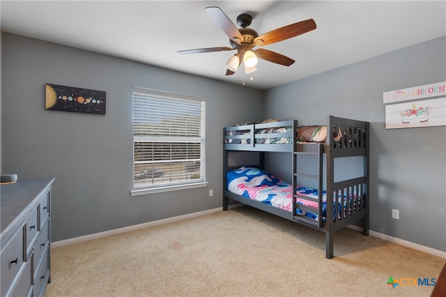 bedroom with ceiling fan and light carpet