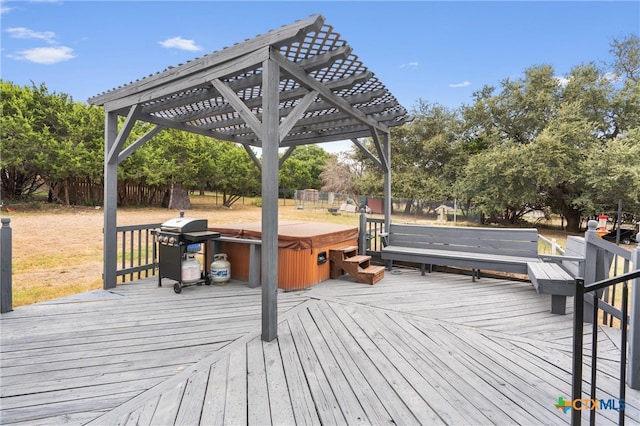 wooden deck with a hot tub, area for grilling, and a pergola