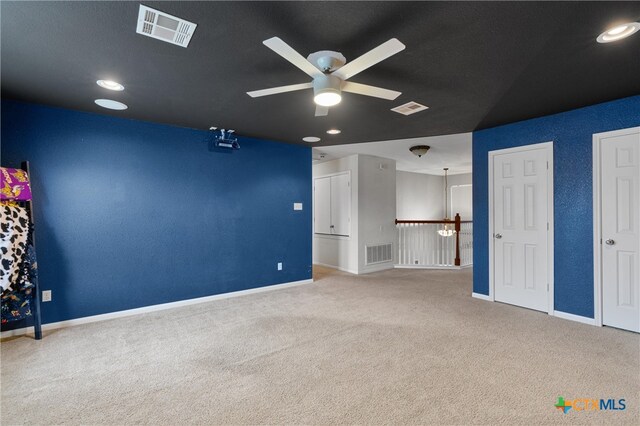 carpeted empty room featuring ceiling fan