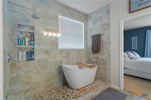 bathroom with shower with separate bathtub