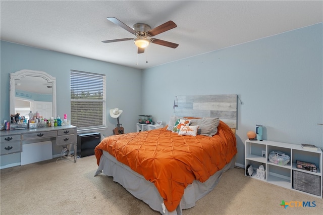 carpeted bedroom with a textured ceiling and ceiling fan