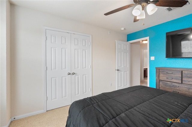 carpeted bedroom featuring a closet and ceiling fan