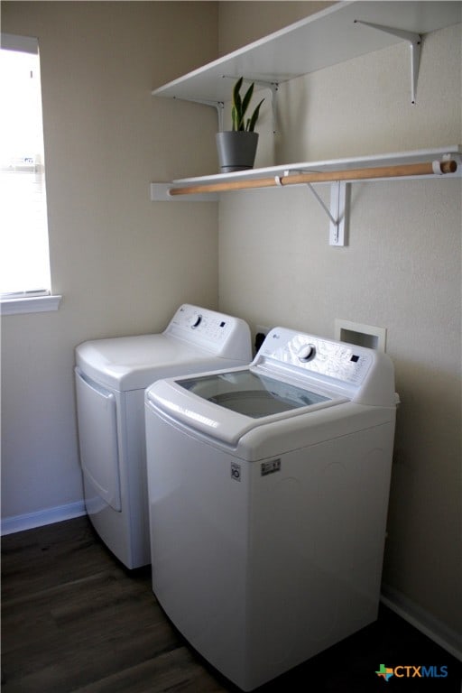 clothes washing area featuring separate washer and dryer and dark hardwood / wood-style flooring