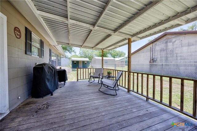207 River St, Hallettsville, TX 77964 - wooden deck featuring a grill, an outdoor structure, and fence