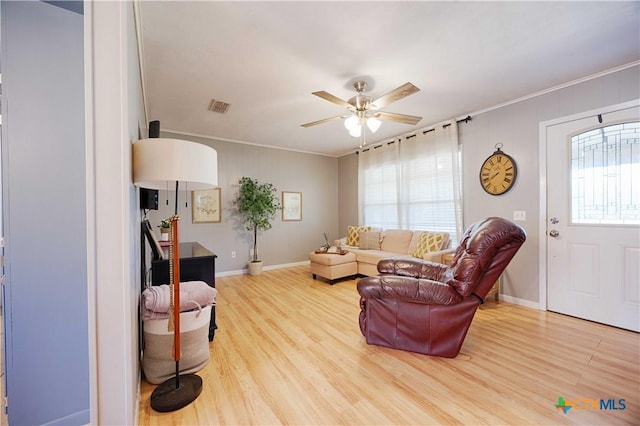 207 River St, Hallettsville, TX 77964 - living room featuring ornamental molding, wood finished floors, ceiling fan, and baseboards