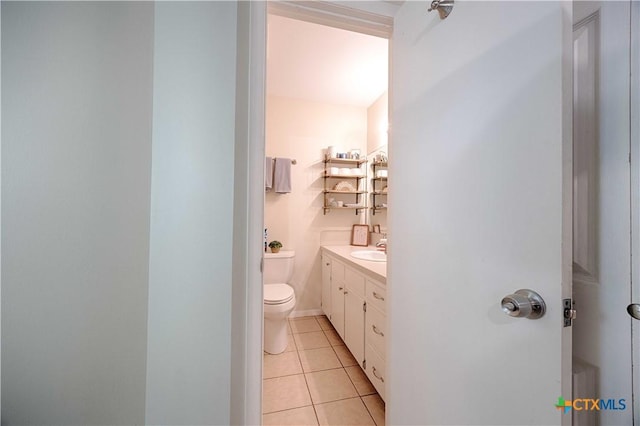 207 River St, Hallettsville, TX 77964 - bathroom with toilet, vanity, and tile patterned flooring