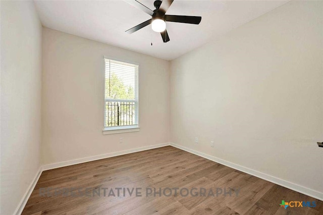 spare room with a ceiling fan, wood finished floors, and baseboards