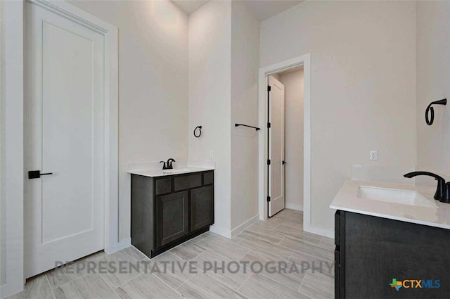 full bathroom featuring vanity and baseboards
