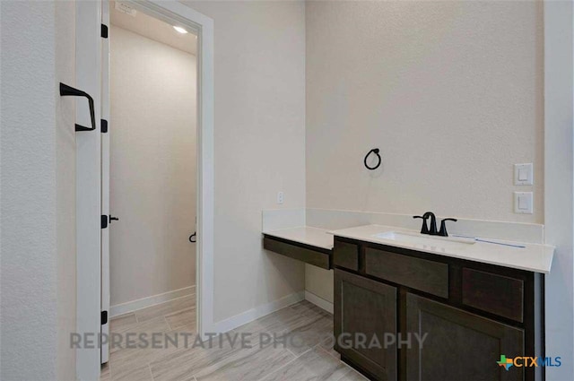bathroom with baseboards and vanity
