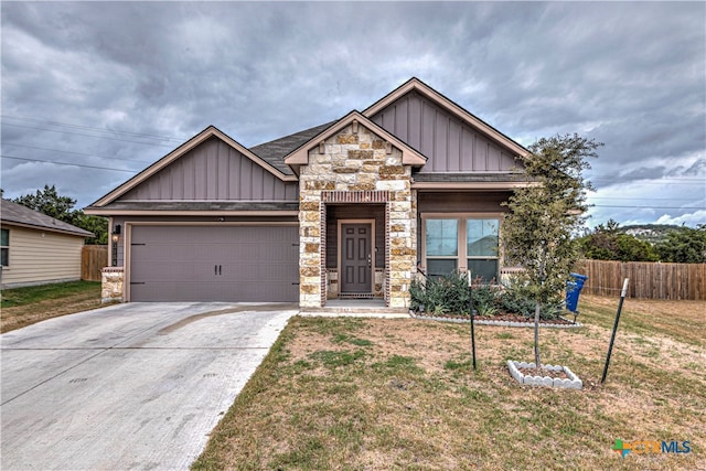 craftsman house with a garage and a front lawn