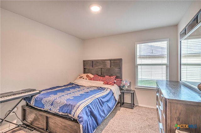 bedroom with light colored carpet