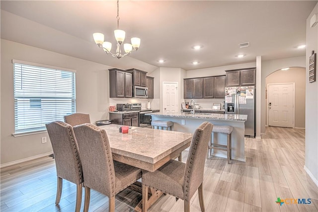 3154 Wigeon Way, Copperas Cove, TX 76522 - dining area with a chandelier, baseboards, light wood finished floors, and recessed lighting