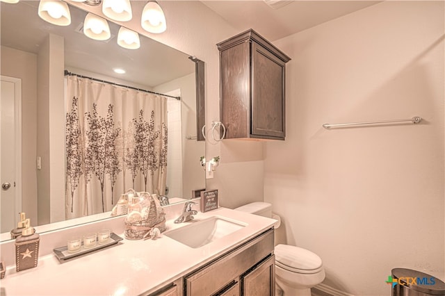 bathroom featuring vanity, curtained shower, and toilet